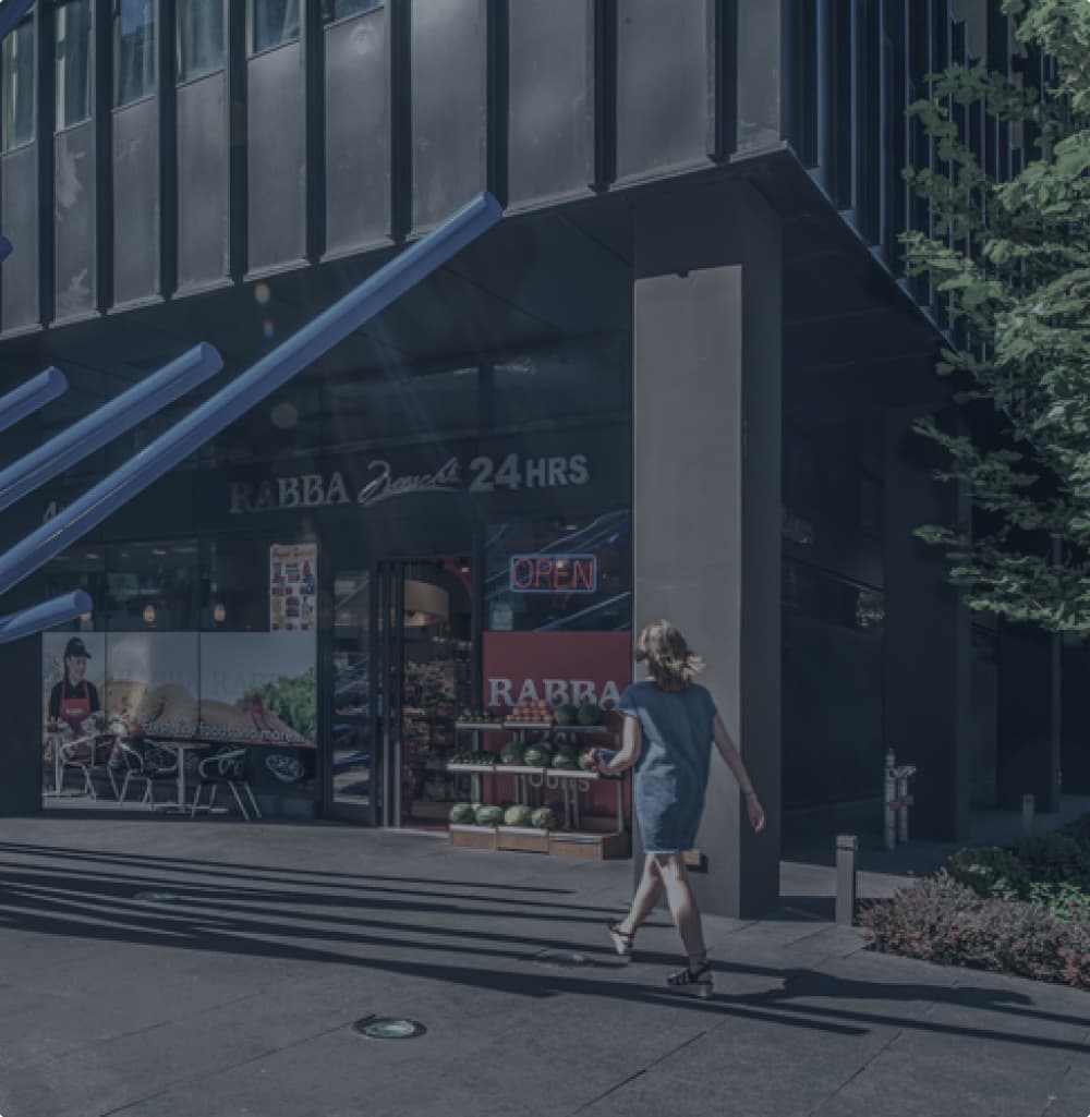 A woman approaching a convenience store